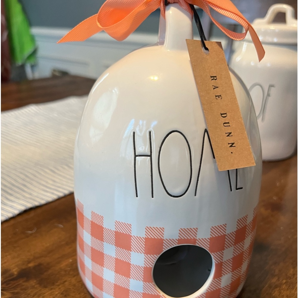 Rae Dunn white and peach colored bird house.